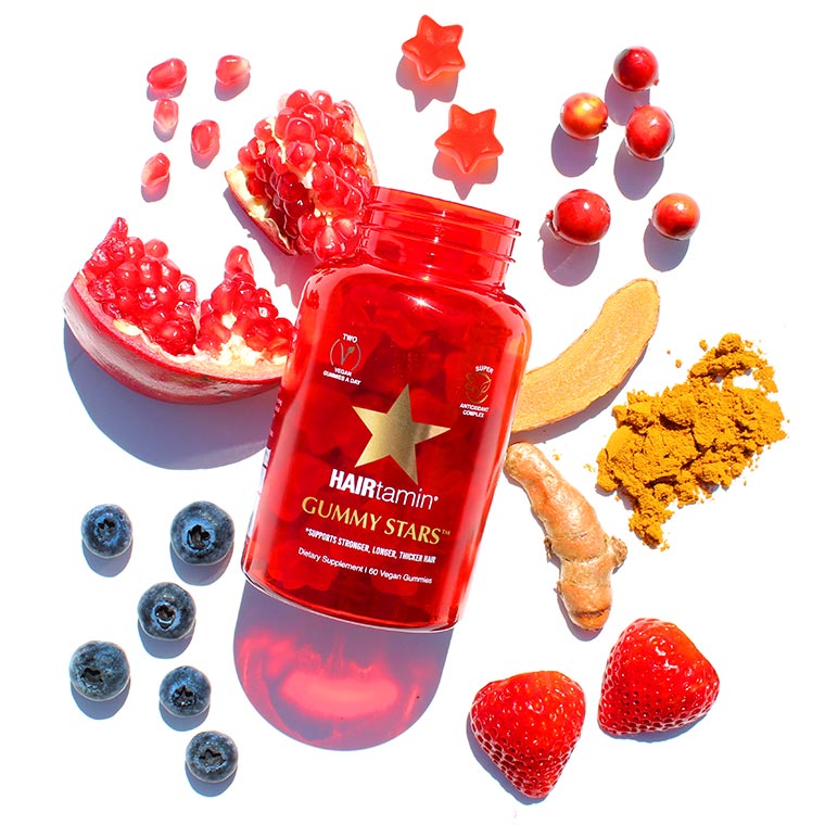 Gummy stars bottle surrounded by fresh ingredients