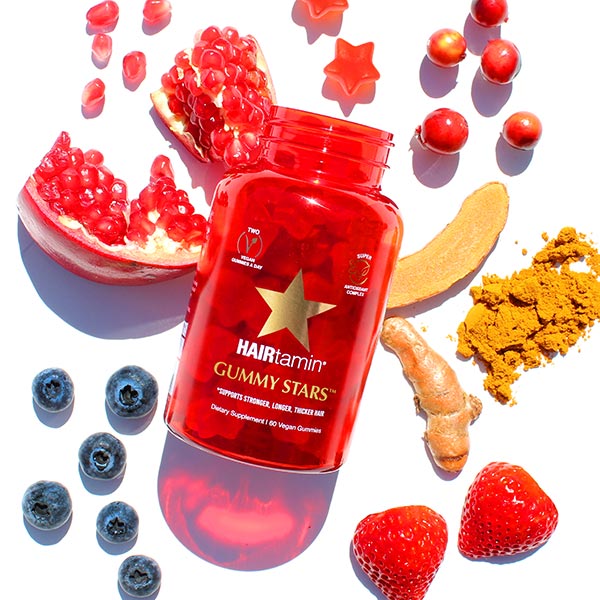 Gummy stars bottle surrounded by fresh ingredients