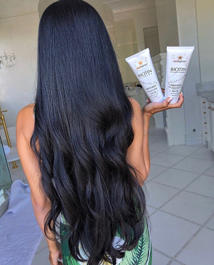 leyla milani holding biotin shampoo and conditioner bottles