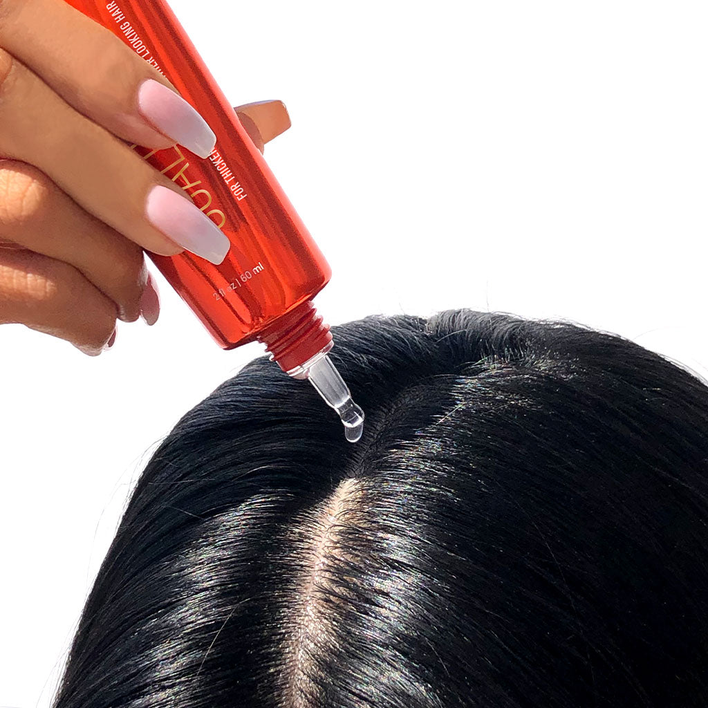 Applying scalp serum to scalp
